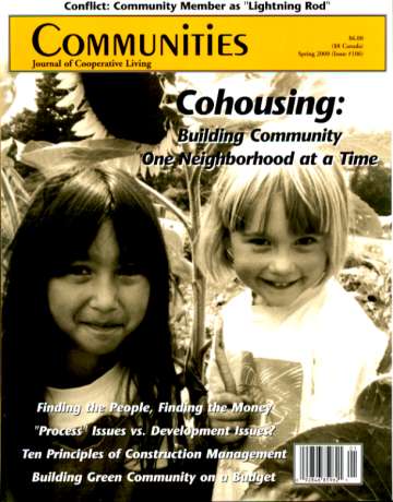 Children smiling on the cover of Communities magazine about cohousing and community building.