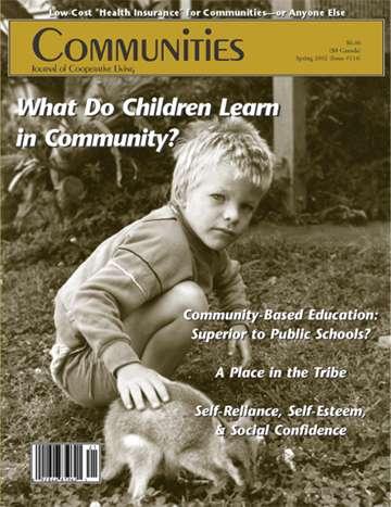 Child sitting outdoors with a dog, in black and white, on Communities magazine cover.