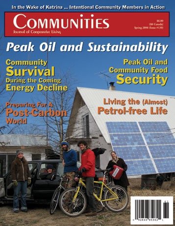 Community members with bicycles and solar panels on a house for sustainability.