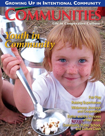 Young girl with red hair and freckles holding a spoon with marshmallows.