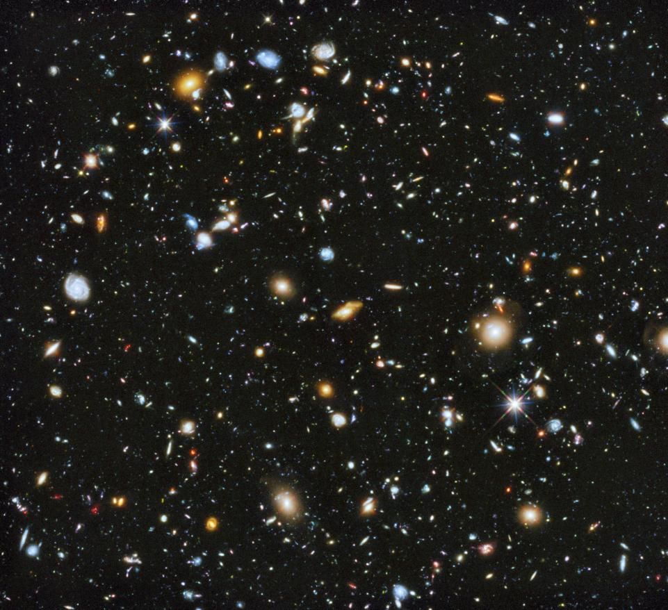 Deep space image showing numerous galaxies and stars in the universe.