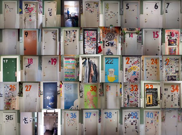 Colorful community mailboxes with decorated doors and numbered labels.