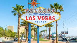 Welcome to Las Vegas Nevada sign with palm trees and blue sky.