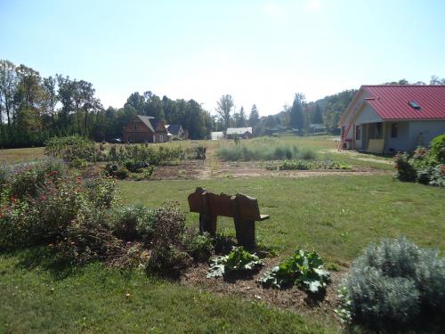 Scenic view of a community garden with houses and greenery in the background.
