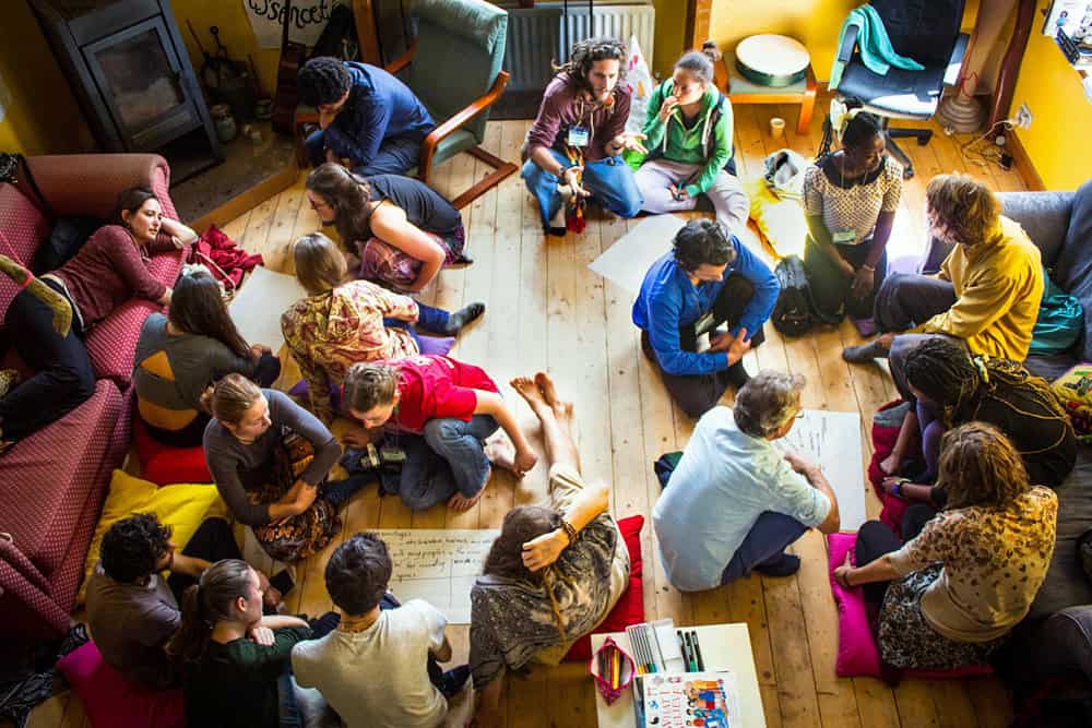 Group of diverse people engaging in a community discussion indoors.