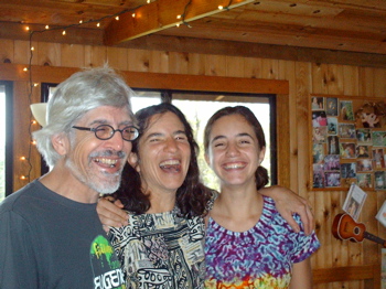 Three people smiling together at the Foundation for Intentional Community event.