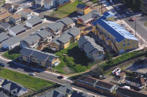 Aerial view of a residential community with colorful houses and green spaces.