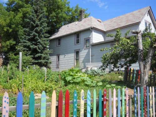 Community house with garden and colorful fence at Foundation for Intentional Community.