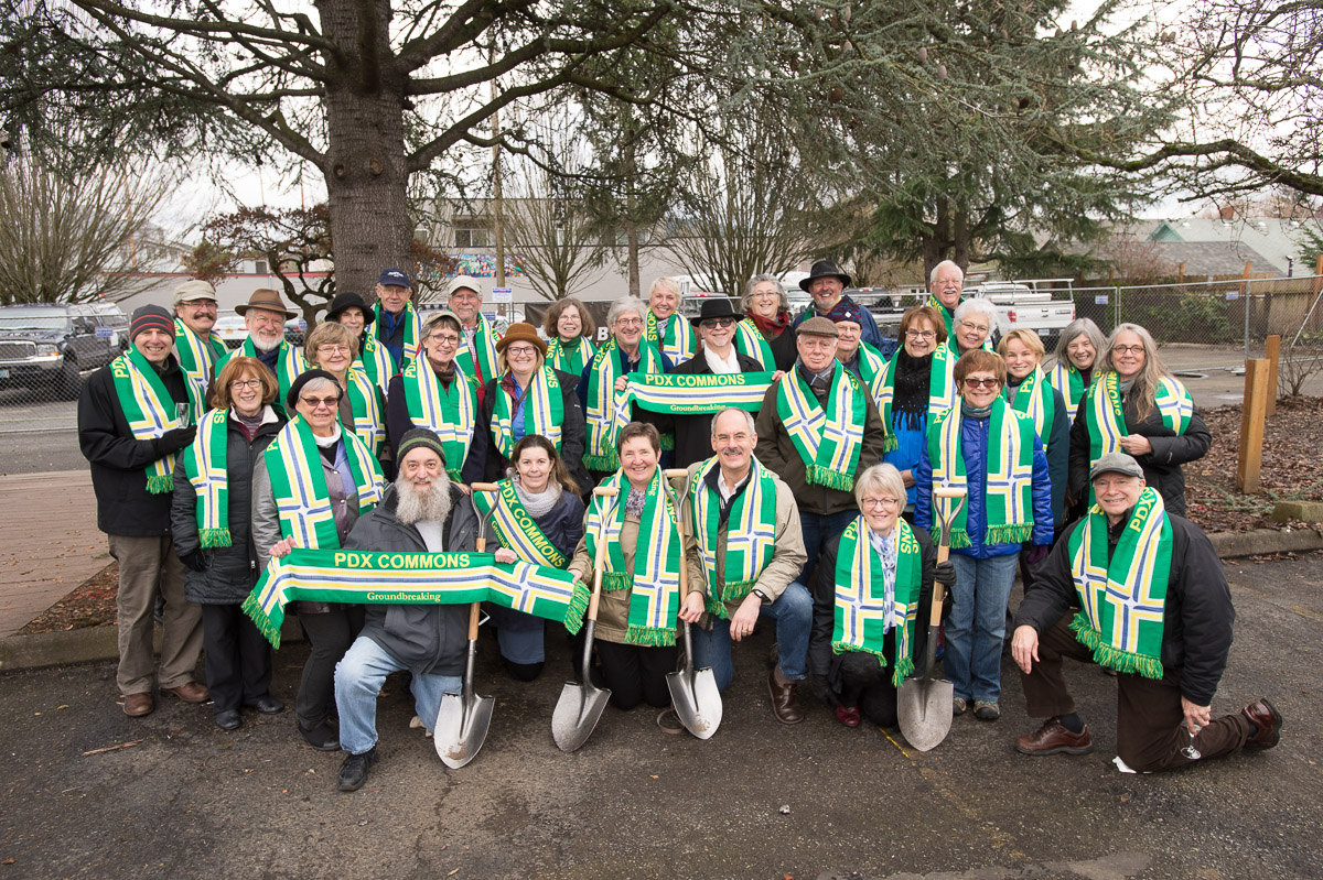 Group of diverse people at PDX Commons community event with scarves and shovels.