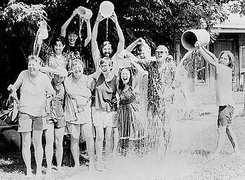Group of children playing with water in a community setting at Twin Oaks.