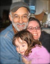 Happy family embracing, representing community and family values.