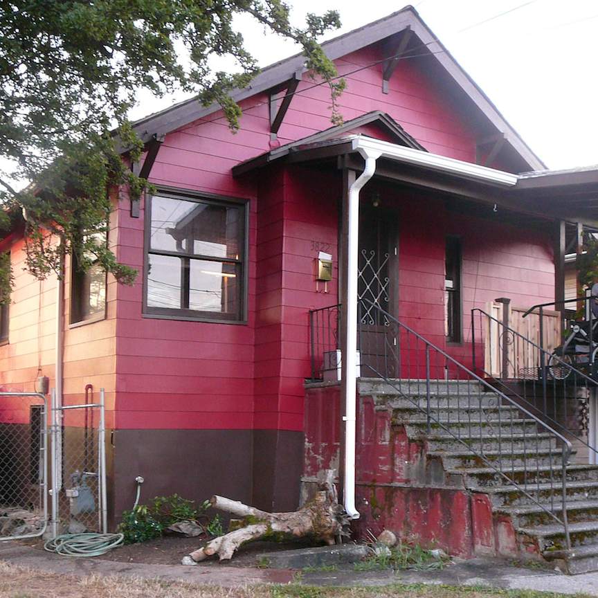 Colorful red house with stairs and greenery in Seattle, Washington.