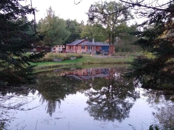 Scenic view of a house by a pond at Balsam Moon Preserve.