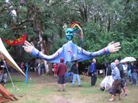 Colorful puppet with rainbow and cloud design at community event.