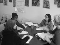 Group of diverse people in a meeting discussing community initiatives.