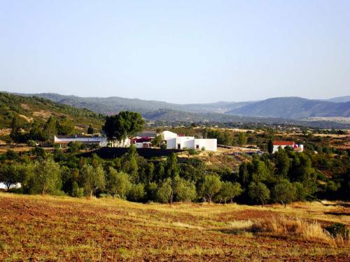 Scenic view of a sustainable community with white buildings in a rural landscape.