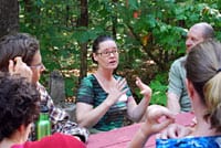 Group of people engaged in a discussion outdoors at a community event.