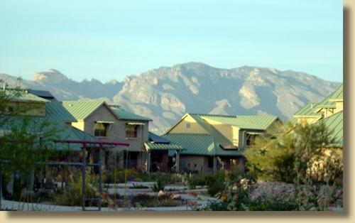 Scenic view of Milagro Cohousing with mountains in the background and eco-friendly homes.