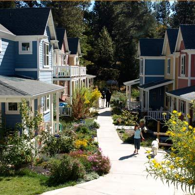 Colorful co-housing community with vibrant houses and lush gardens in Nevada City.
