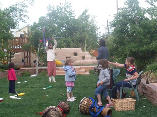 Children playing outdoor games in a community garden setting.