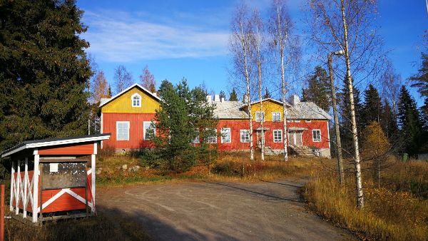 Colorful community building with trees and clear sky in the background.