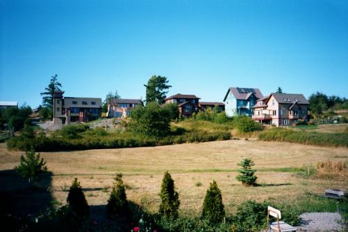 Scenic view of cohousing community with modern homes and green landscape.