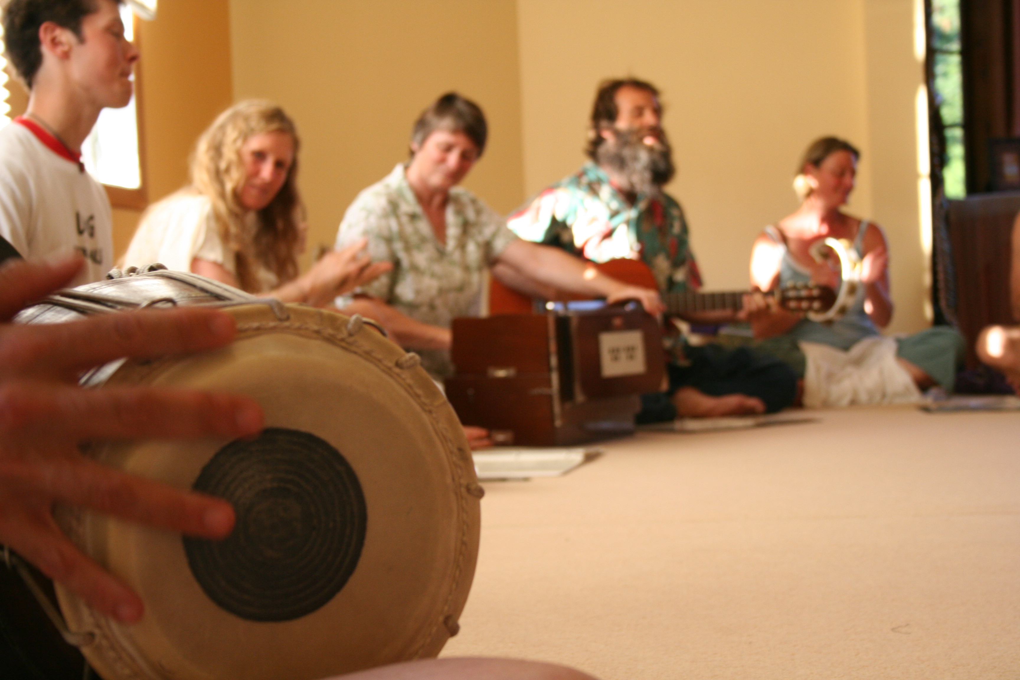 Group of people playing musical instruments in a community setting.