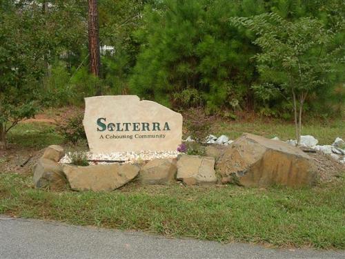 Solterra community sign with natural stone border and greenery.