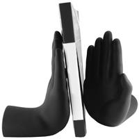 Black gloves holding a book with a white cover and black spine.