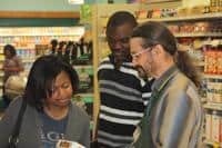 People engaging in a community discussion at a local store or event.