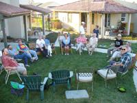 Community gathering outdoors at Foundation for Intentional Community event.