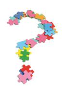Colorful puzzle pieces forming a question mark symbolizing community and inquiry.