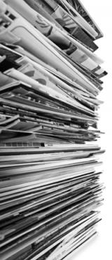 Stack of papers and documents related to intentional community projects.