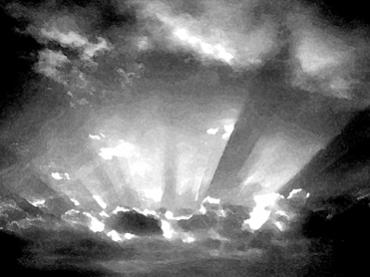 Sun rays breaking through clouds over a mountain landscape in black and white.