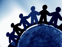 Diverse group of people holding hands around the globe symbolizing community and connection.