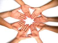 Diverse hands forming a heart shape symbolizing community and unity.