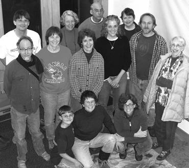 Group of diverse people gathered indoors for a community event at IC.org.