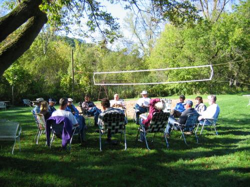 Community gathering outdoors at Wiscoy Valley Community Land Cooperative.