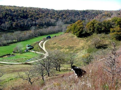 Scenic view of Zephyr Valley Community Co-op with rolling hills and farm buildings.
