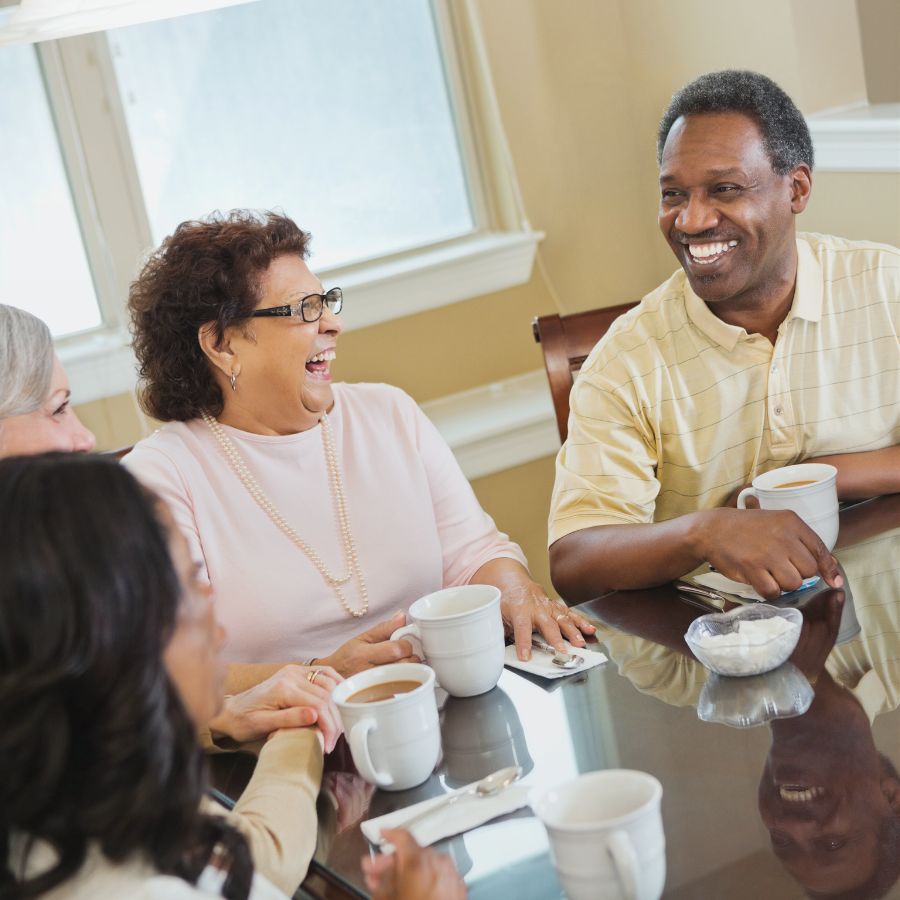 Diverse group of people enjoying coffee and conversation at a community event.