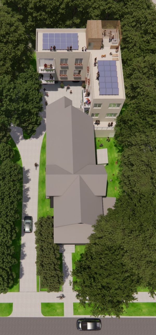 Aerial view of a sustainable community with solar panels and green spaces.