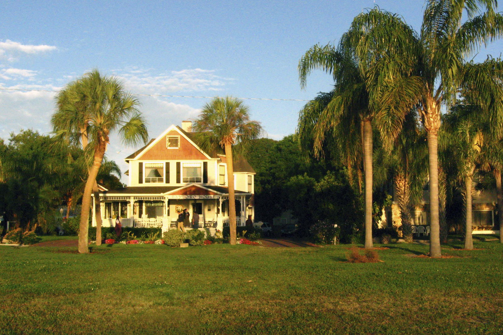 Large historic house surrounded by palm trees at Bayboro Community.