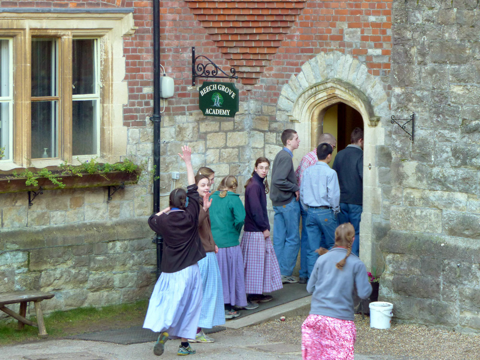 People entering the Foundation for Intentional Community building in a rural setting.