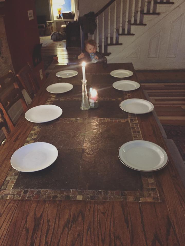 Family dinner table with plates and candles at Baynton East House.