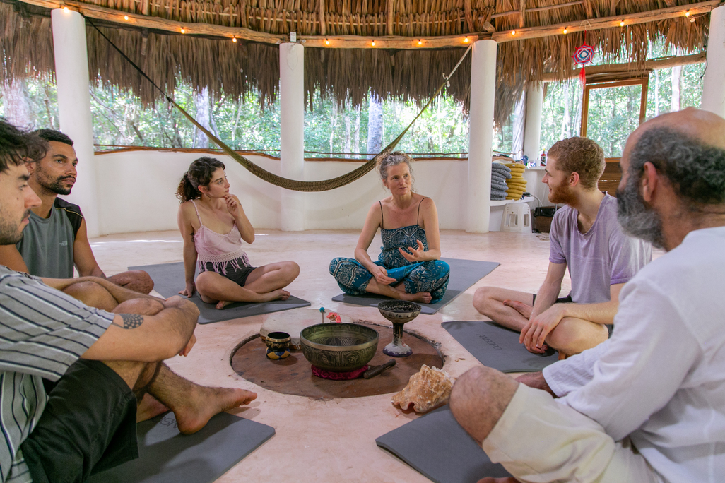 People meditating in a circle at The Foundation for Intentional Community.