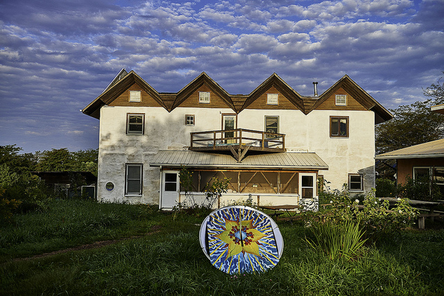 Eco-friendly community home at Dancing Rabbit Ecovillage with garden and sky.