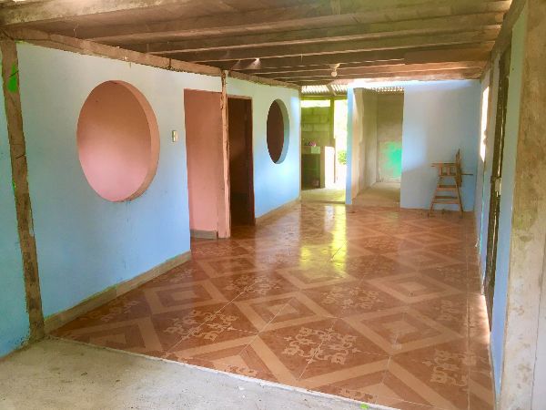 Spacious interior with colorful walls and patterned wooden floor.