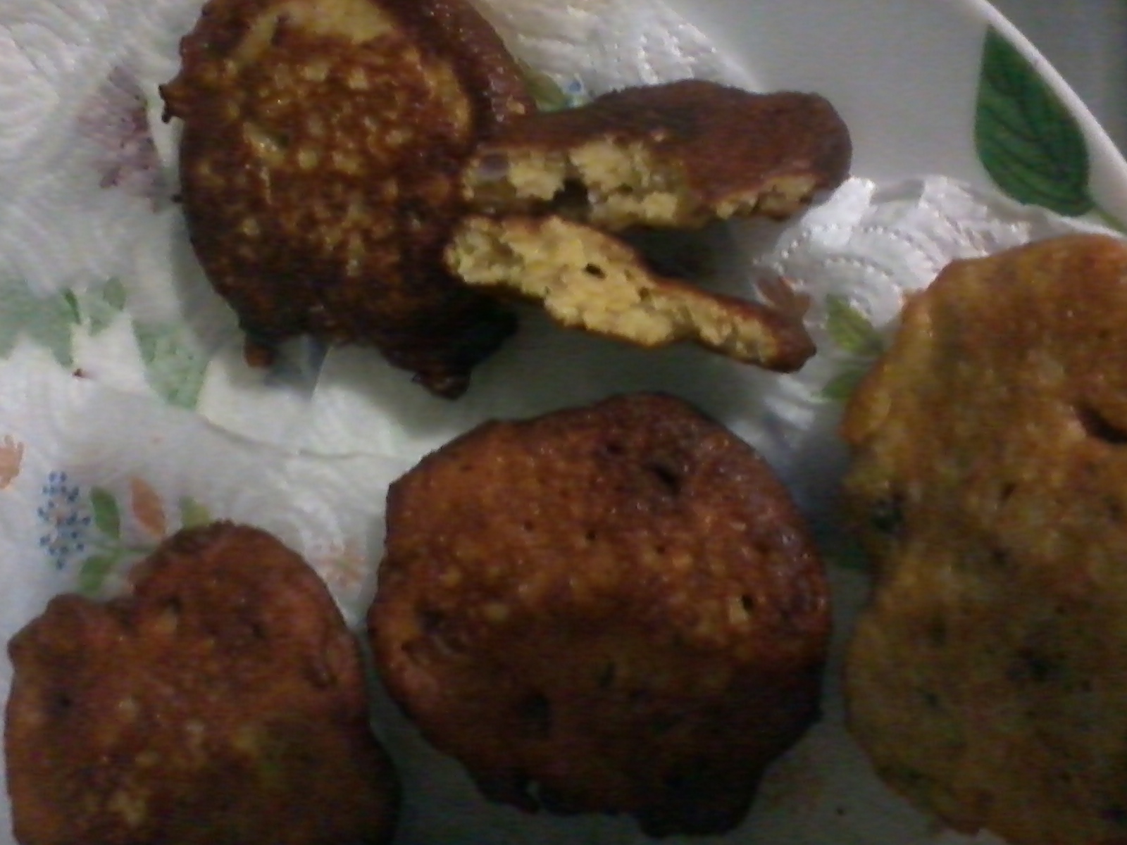 Close-up of fried food items on a plate, including a partially eaten piece.