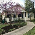 Charming house with garden and trees, outdoor setting.