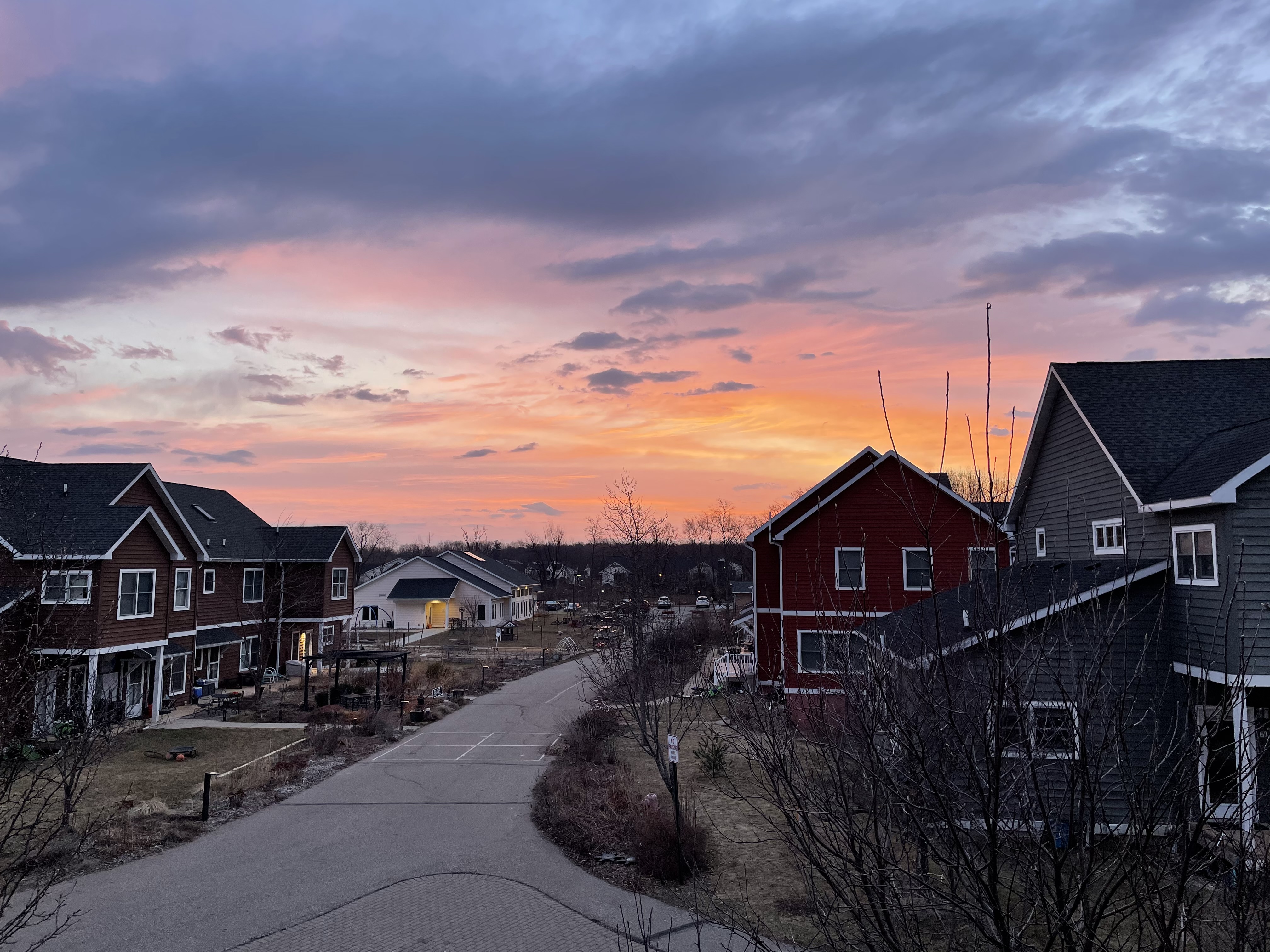 Scenic view of suburban houses during sunset with colorful sky.
